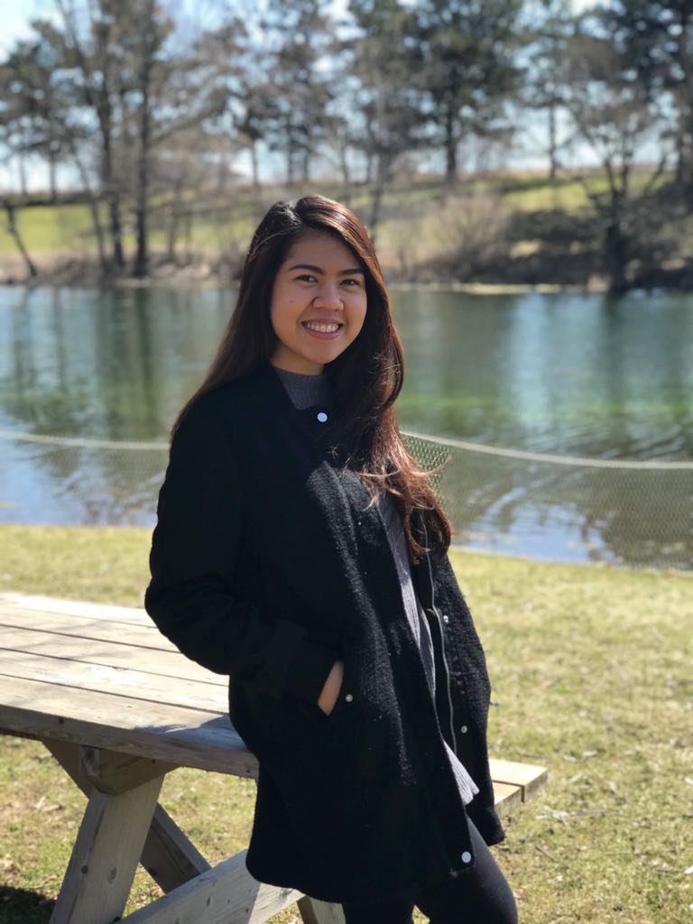 Pauline posing for a backdrop of lake and the blue sky